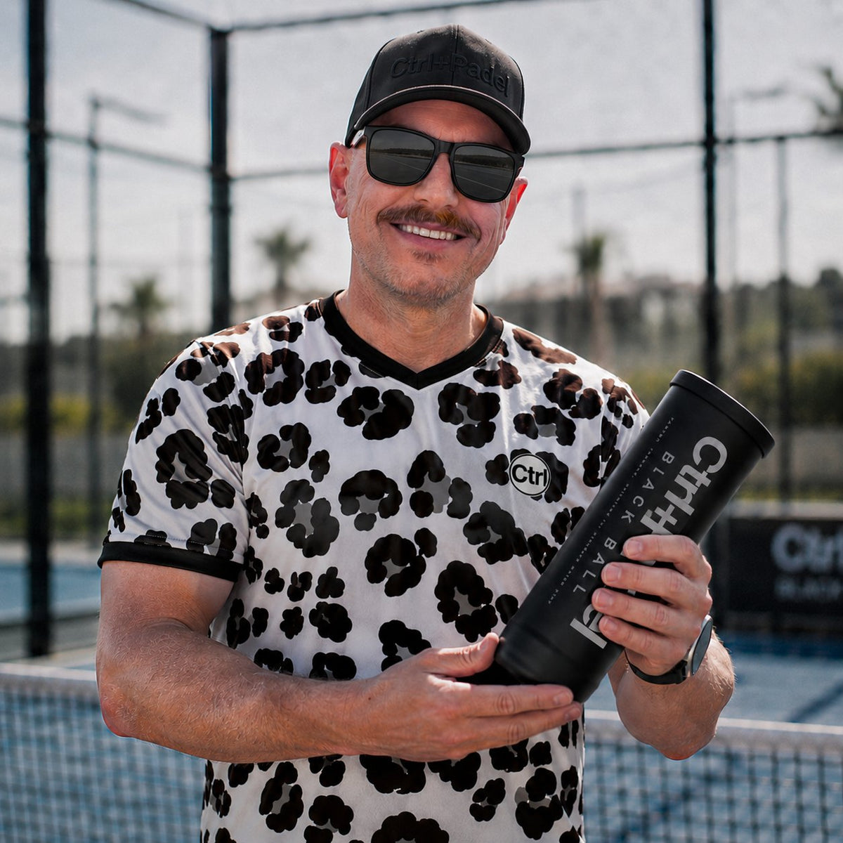 Ctrl+Padel Local with a Black Ball tube on court